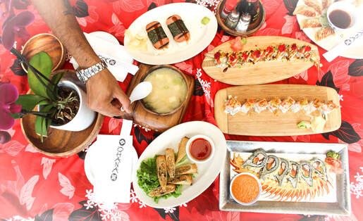 A spread of Ohana sushi rolls, gyoza, and miso soup